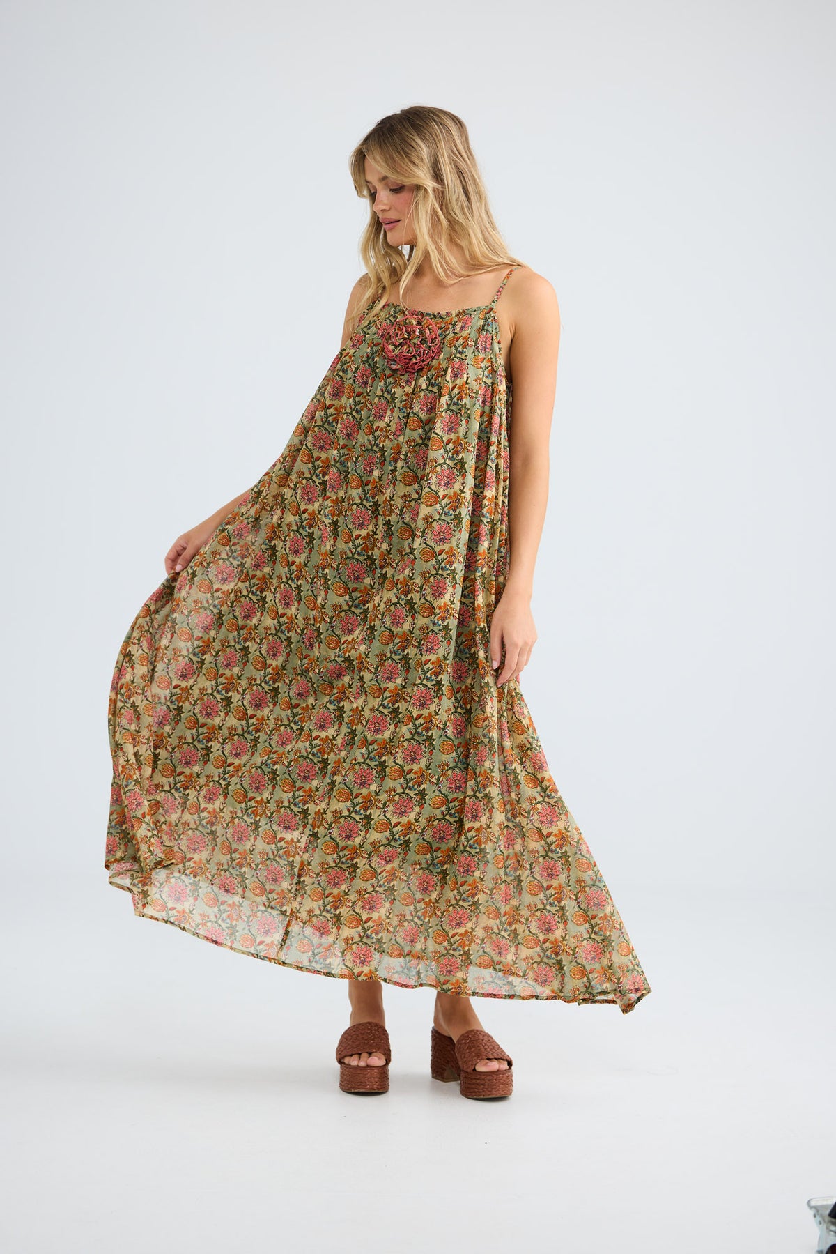 Model wearing Noema Dress in green meadow, front view.