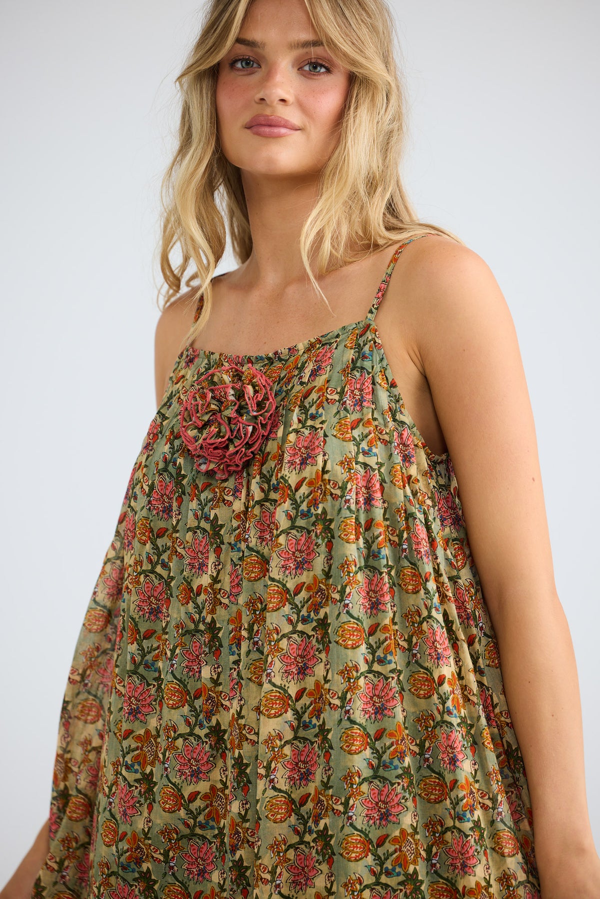 Noema Dress in green meadow with adjustable straps.
