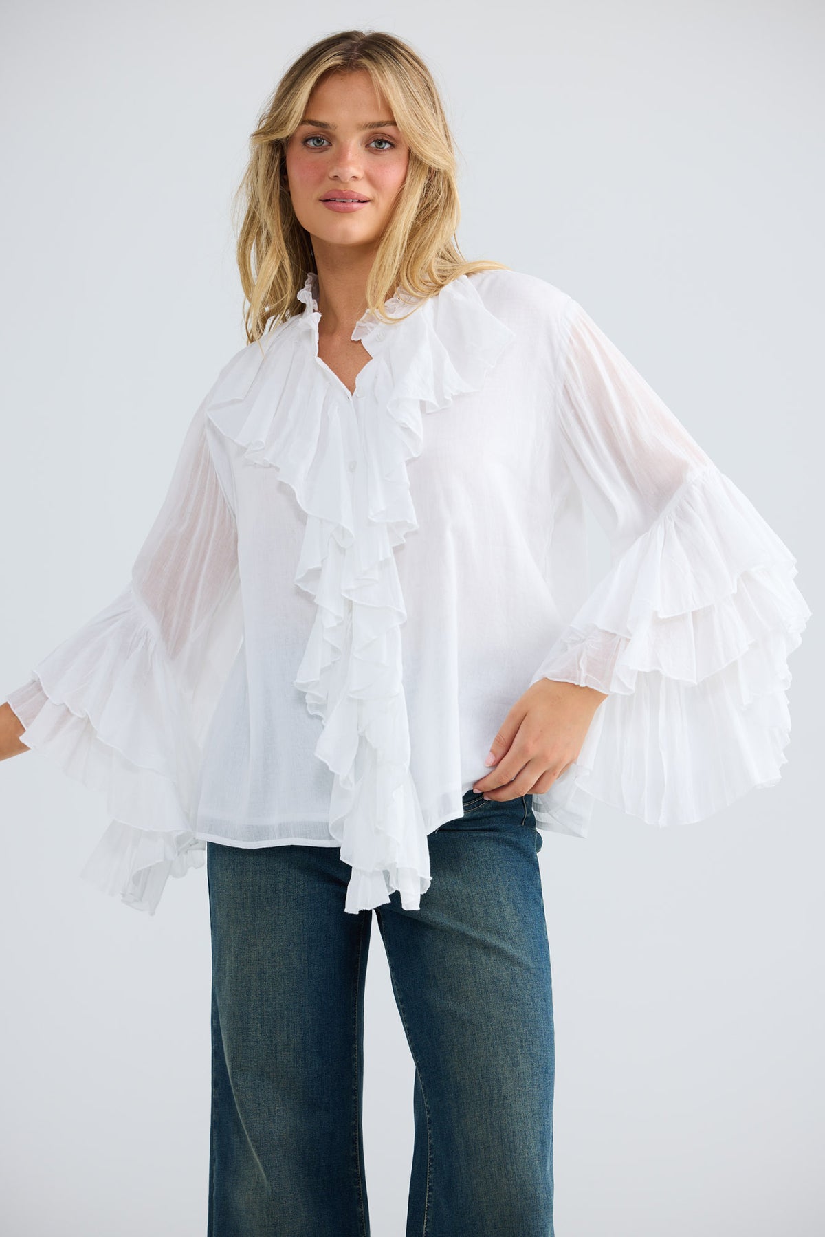 Model wearing Maika Frill Shirt in white, front view.