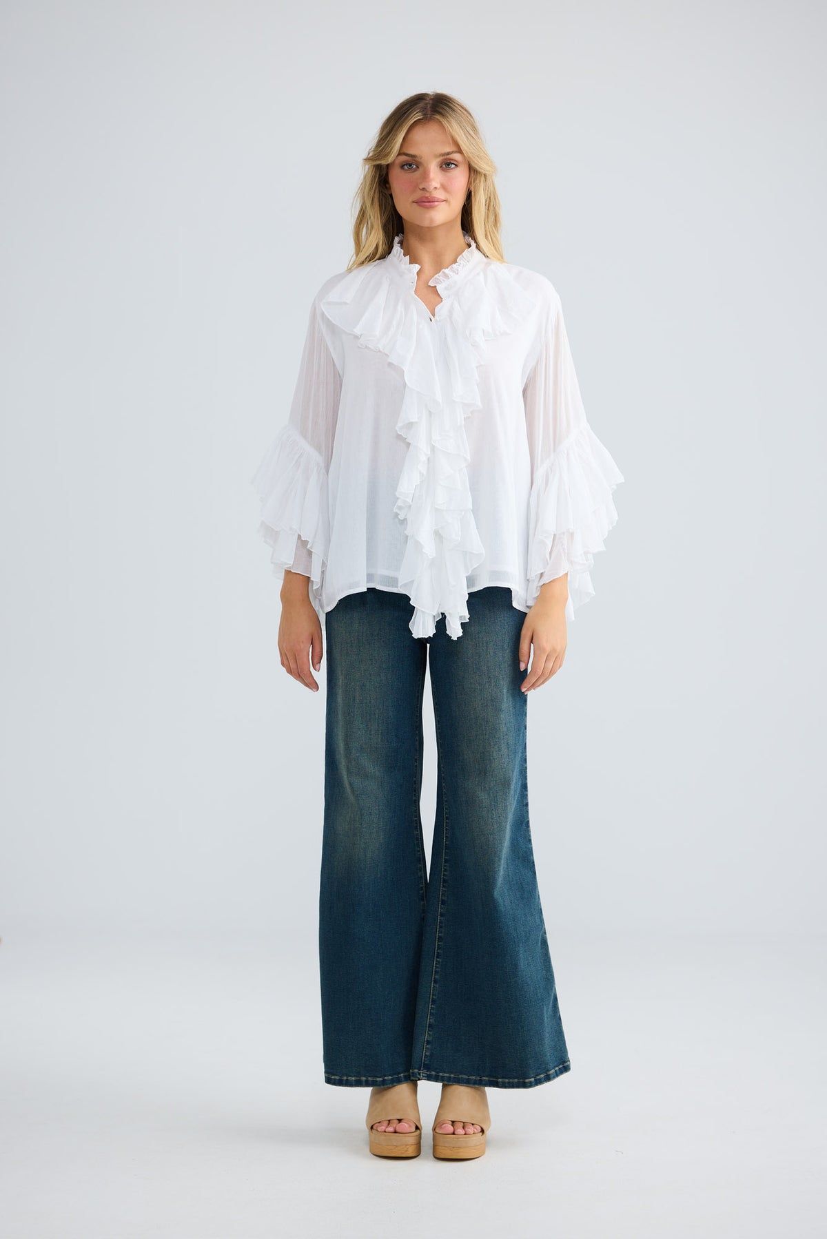 Maika Frill Shirt in white with cascading ruffle details.
