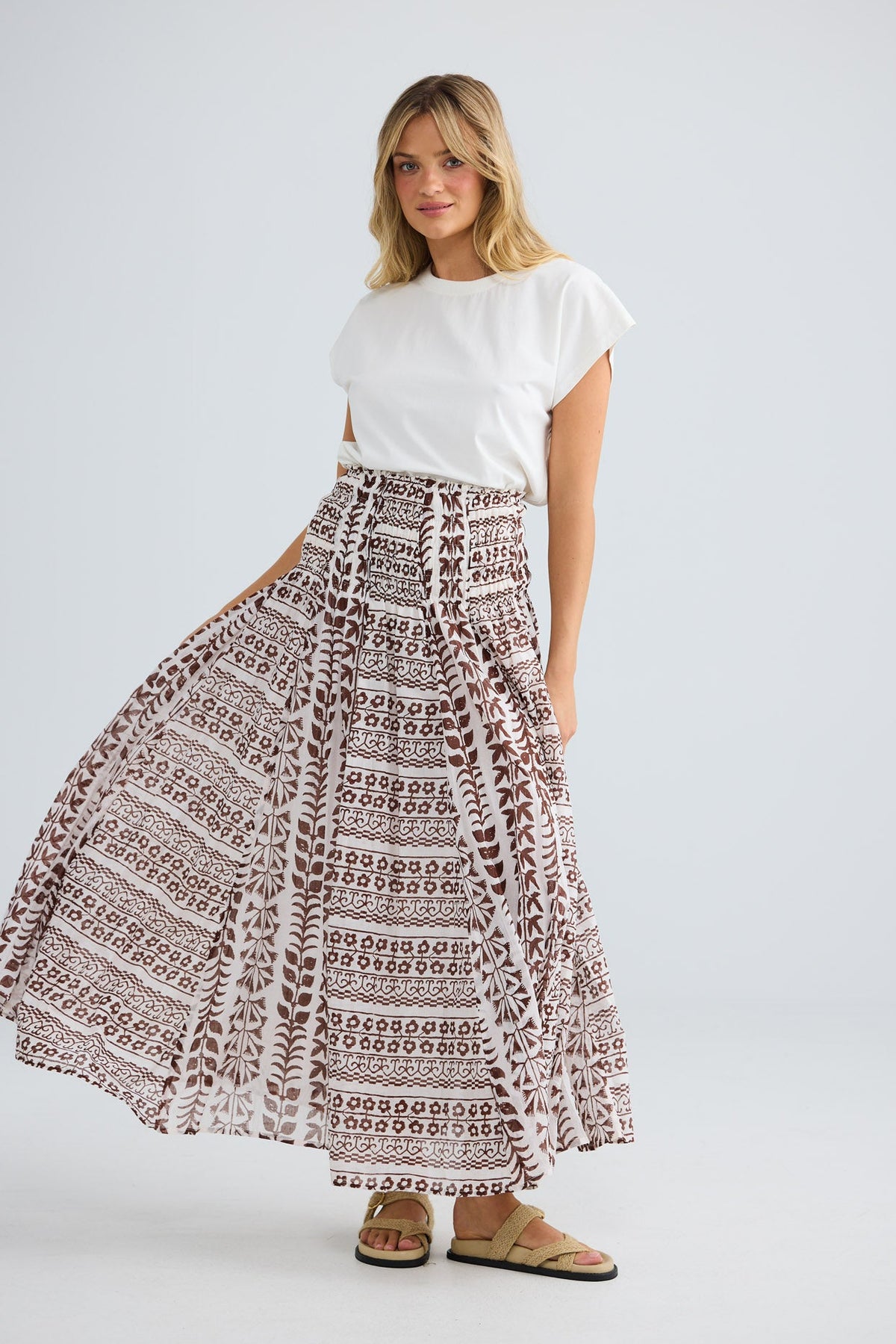 Model wearing Balmoral Skirt in chocolate paro, front view.