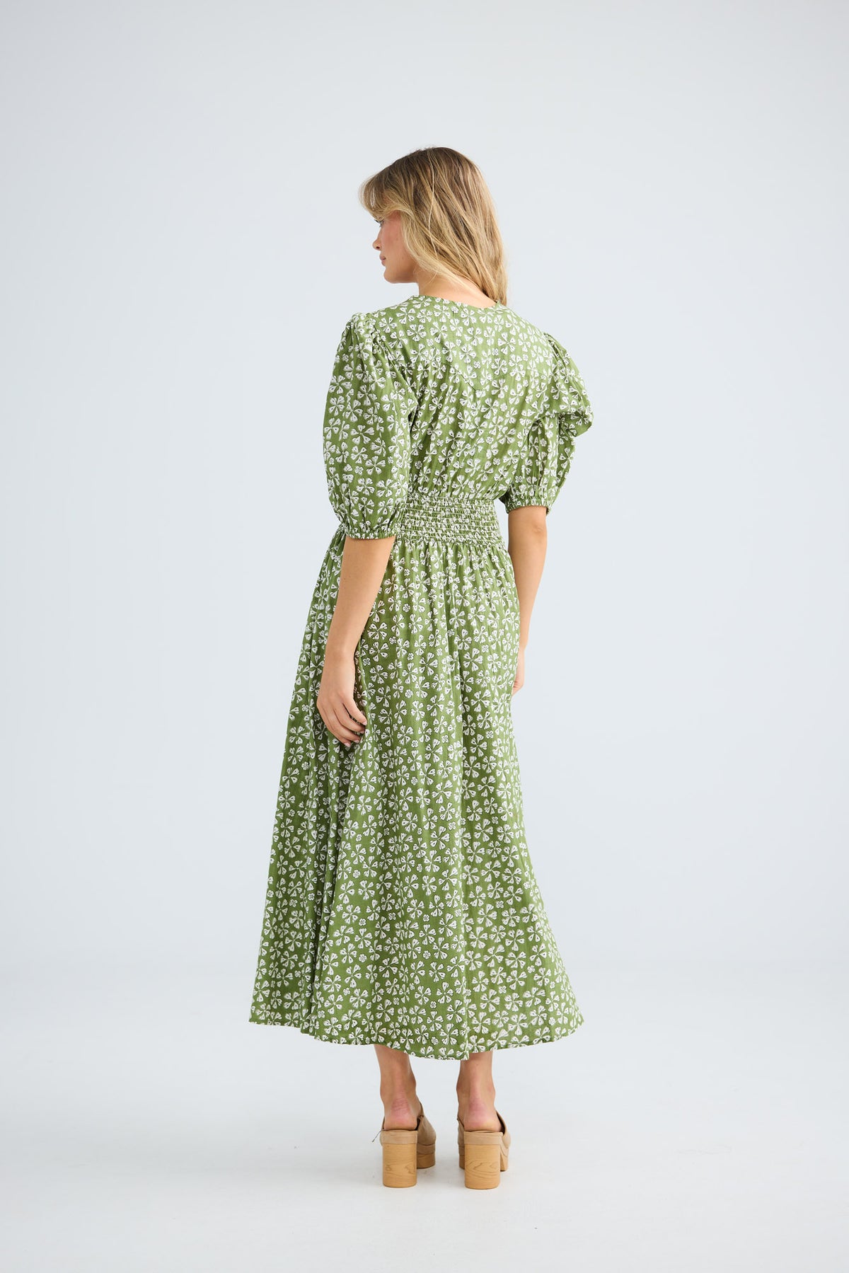 Model wearing Halo Dress in sage petal, front view.