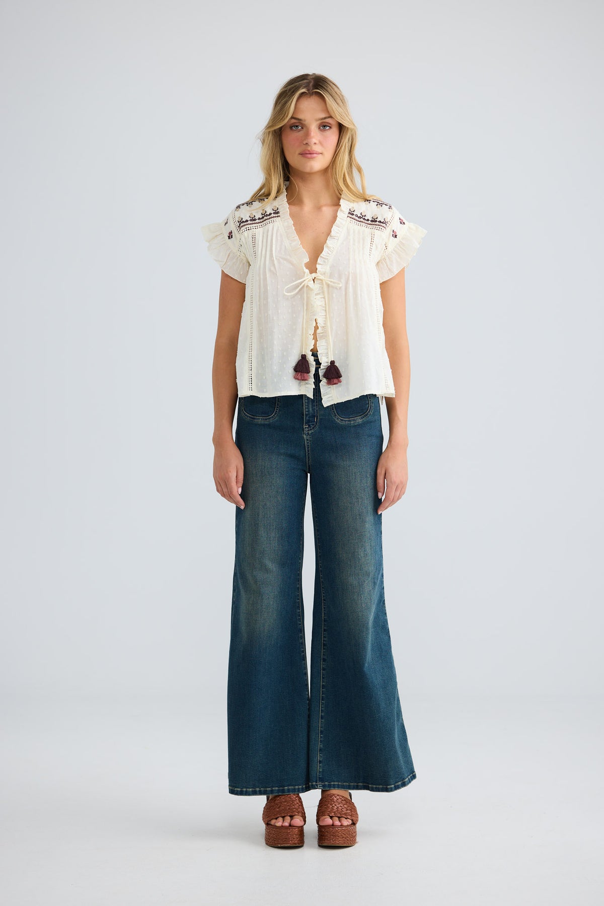 Model wearing Saskia Tie Top in natural dobby, front view.