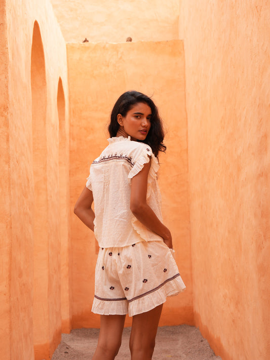 Saskia Tie Top in natural dobby with the Saskia Short, full length in a terracotta archway.