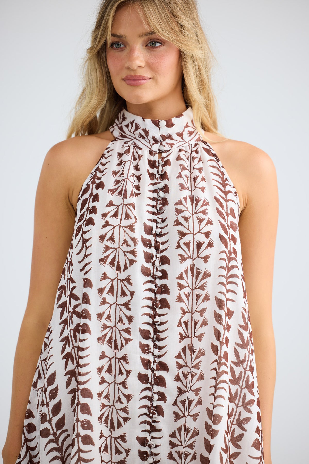 Model wearing Tapas Dress in chocolate paro, front view.