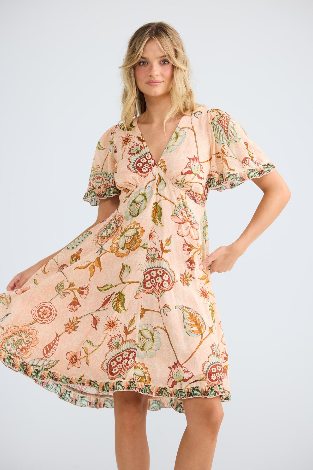 Model wearing Tea Party Dress in wildflower oasis, front view.