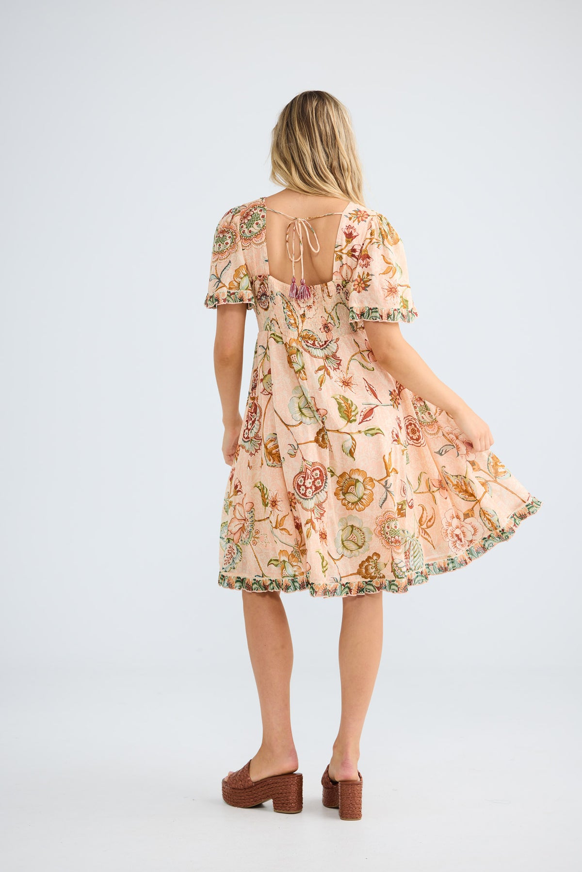 Tea Party Dress in wildflower oasis with a shaped underbust design.