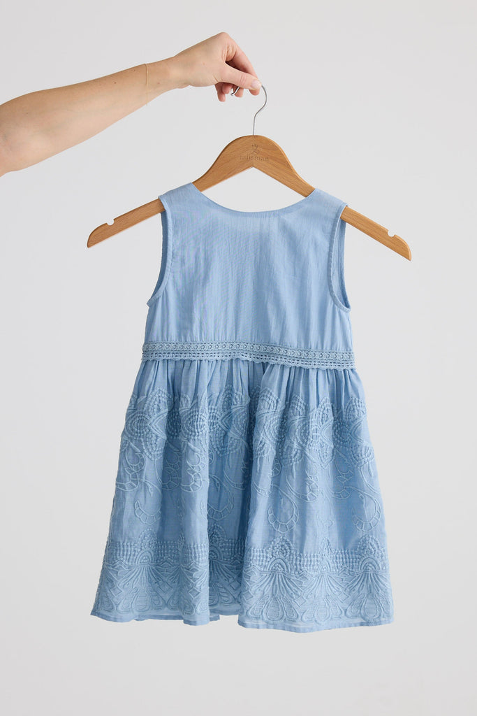Light blue dress on a hanger against a white background