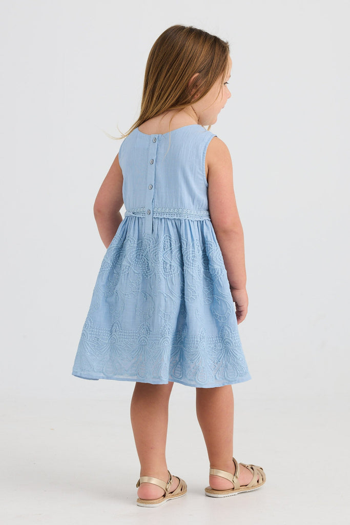 Young girl wearing a light blue dress on a white background